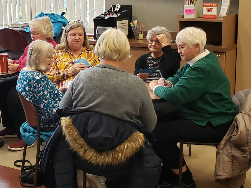 Group of older adults playing cards