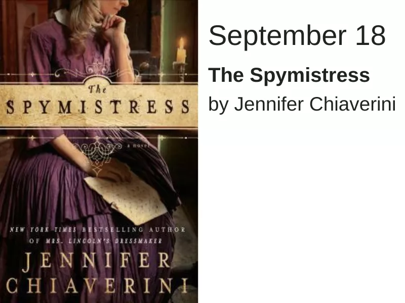 A woman in a purple dress looks down at a piece of paper. The words "The Spymistress" run across the middle